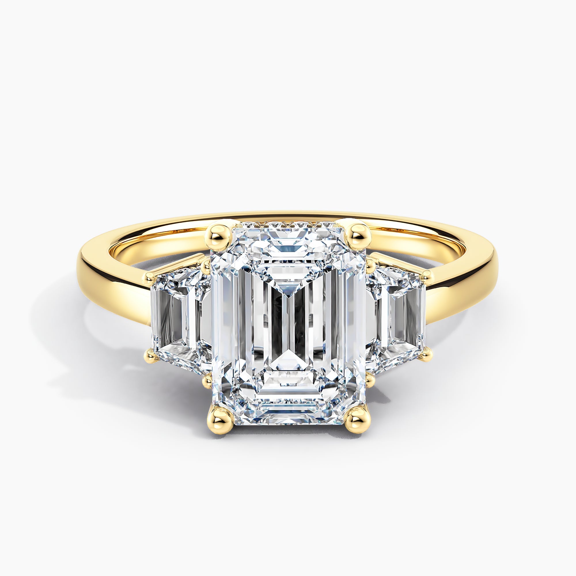 Emerald Cut Three Stone Engagement Ring With Trapezoid Accent Diamonds