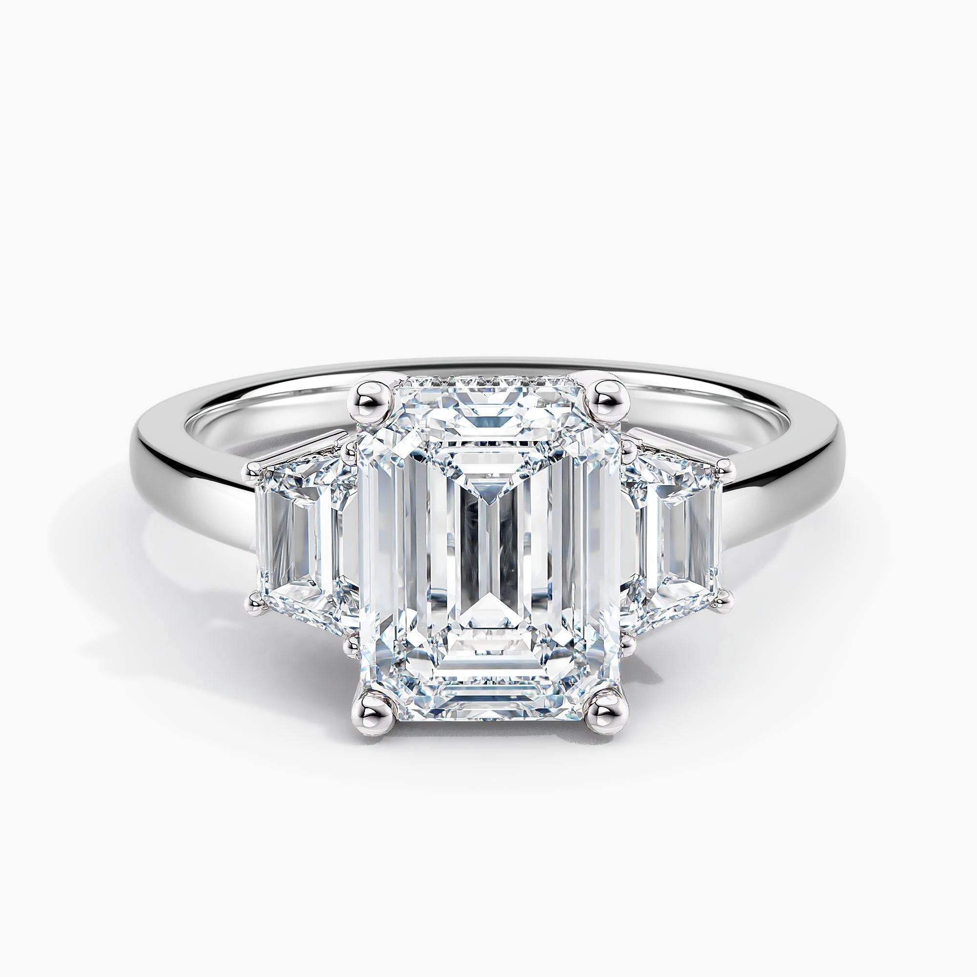 Emerald Cut Three Stone Engagement Ring With Trapezoid Accent Diamonds